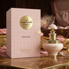 A luxurious product presentation of Juman Precious Eau de Parfum, featuring the soft-toned 100ml bottle displayed beside its ornate, patterned gift box on an elegant marble surface.